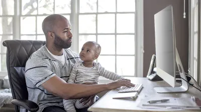 A father with his child accesses his health data online